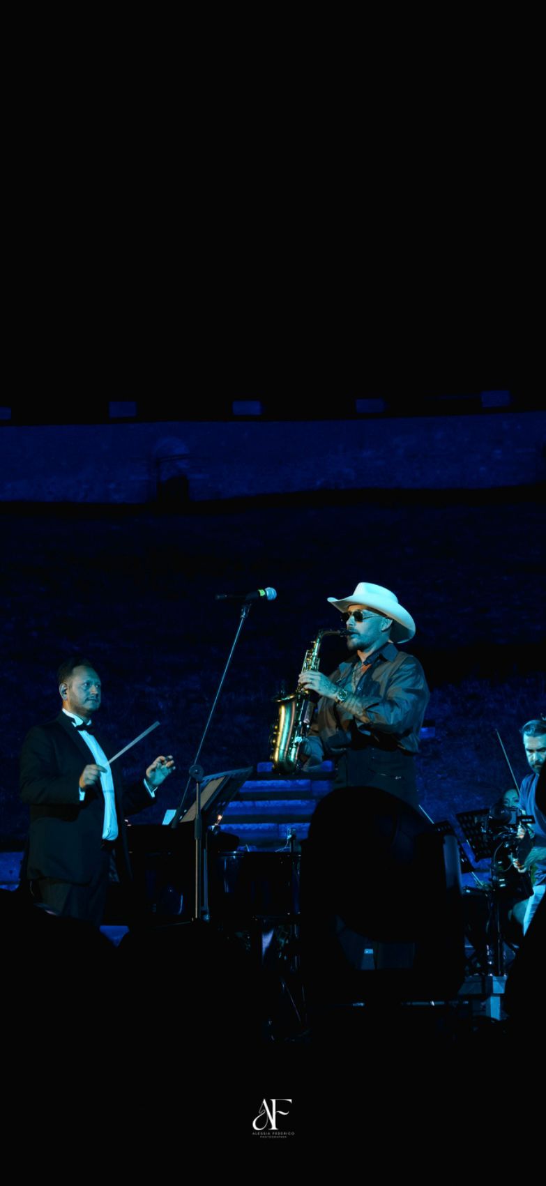 Vincenzo Sorrentino conducting alongside Jimmy Sax on stage